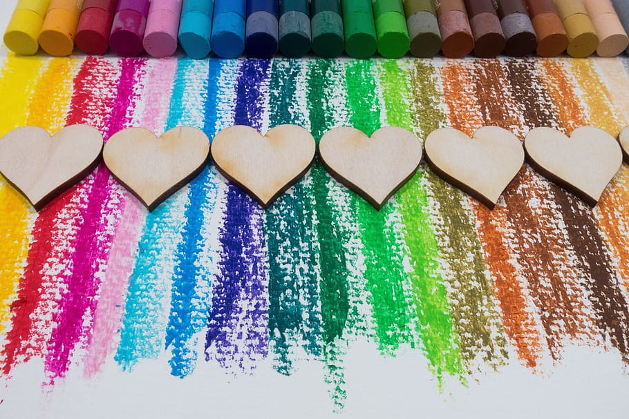 assorted color chalks near heart decoration, color, oil pastels, colorful, heart, laser cut, wood, series, color spectrum, paint, paper, color patterns, yellow, orange, red, pink, blue, violet, green, brown, love, affection, feeling, HD wallpaper