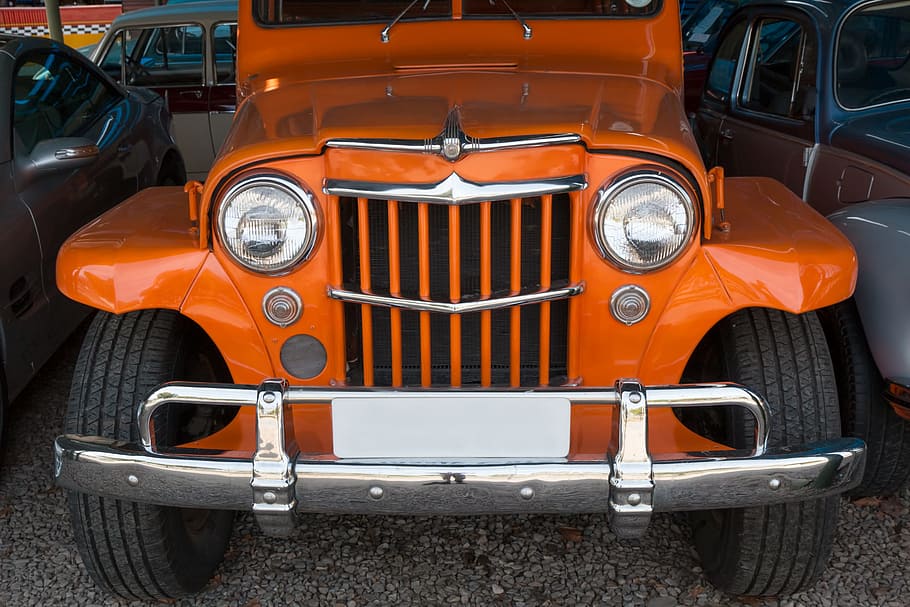 orange Jeep Wrangler parked near vehicles, motor car, grille, willys jeep, station wagon, 4x4, four by four, headlights, bumper, strong, car, motor, vehicle, transportation, headlight, automobile, auto, front, retro, classic, old, transport, vintage, nostalgia, american, chrome, trusty, reliable, off road, HD wallpaper