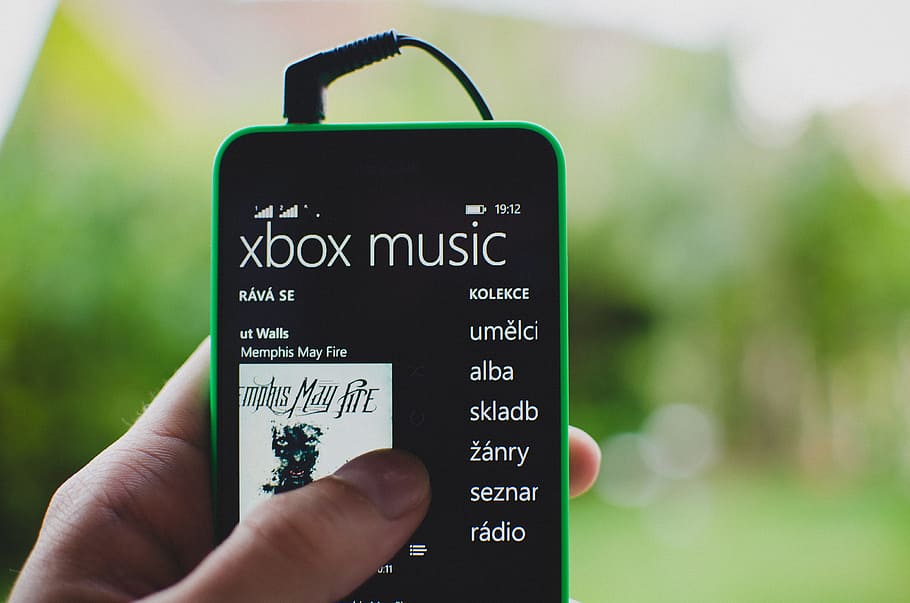 Green and black smartphone displaying Xbox music close-up photography ...