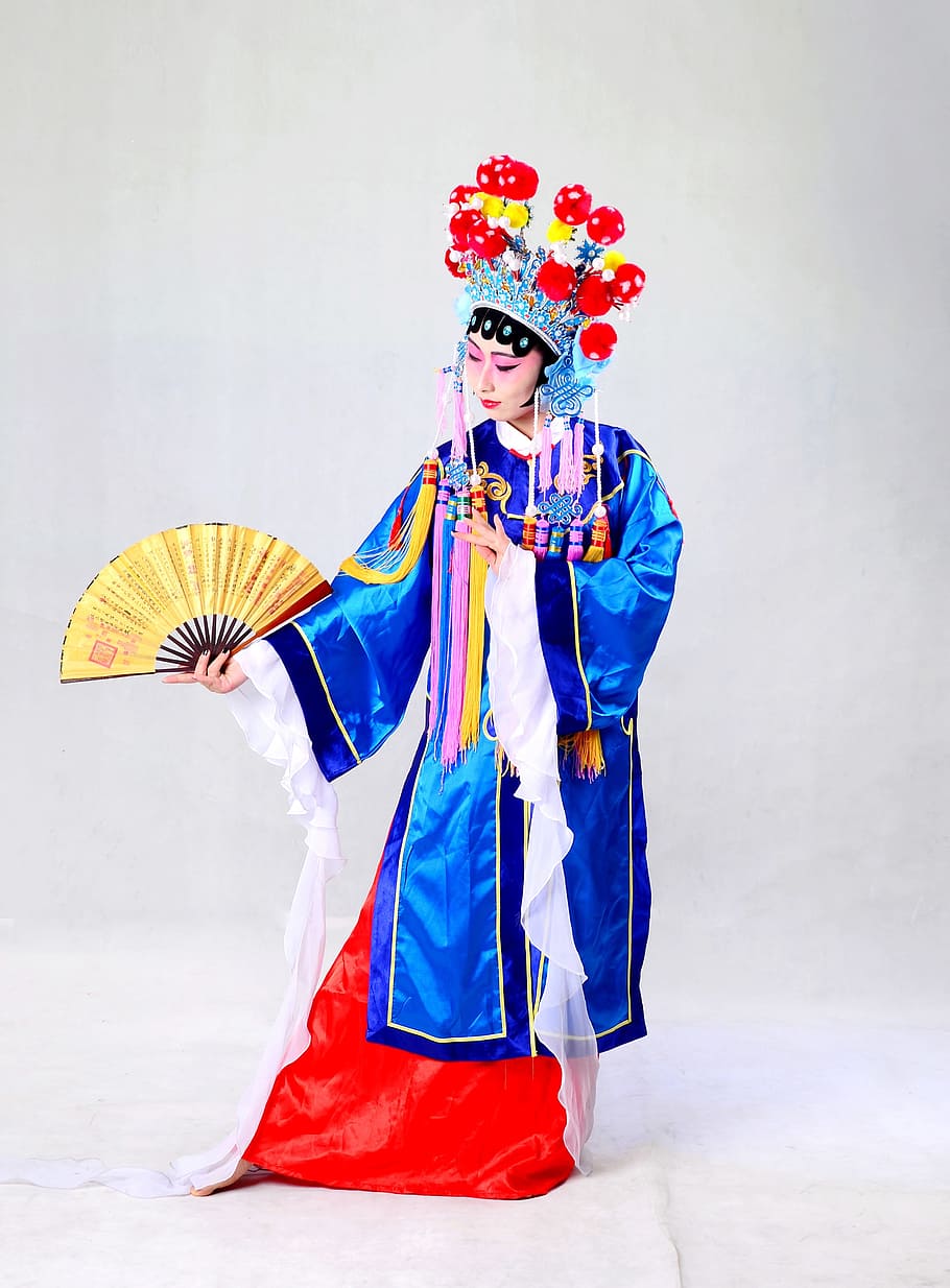 Woman wearing blue, white, and red traditional coat, beijing opera ...